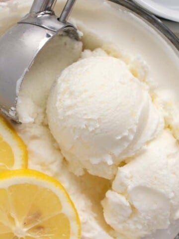 scooping lemon gelato out of a bowl