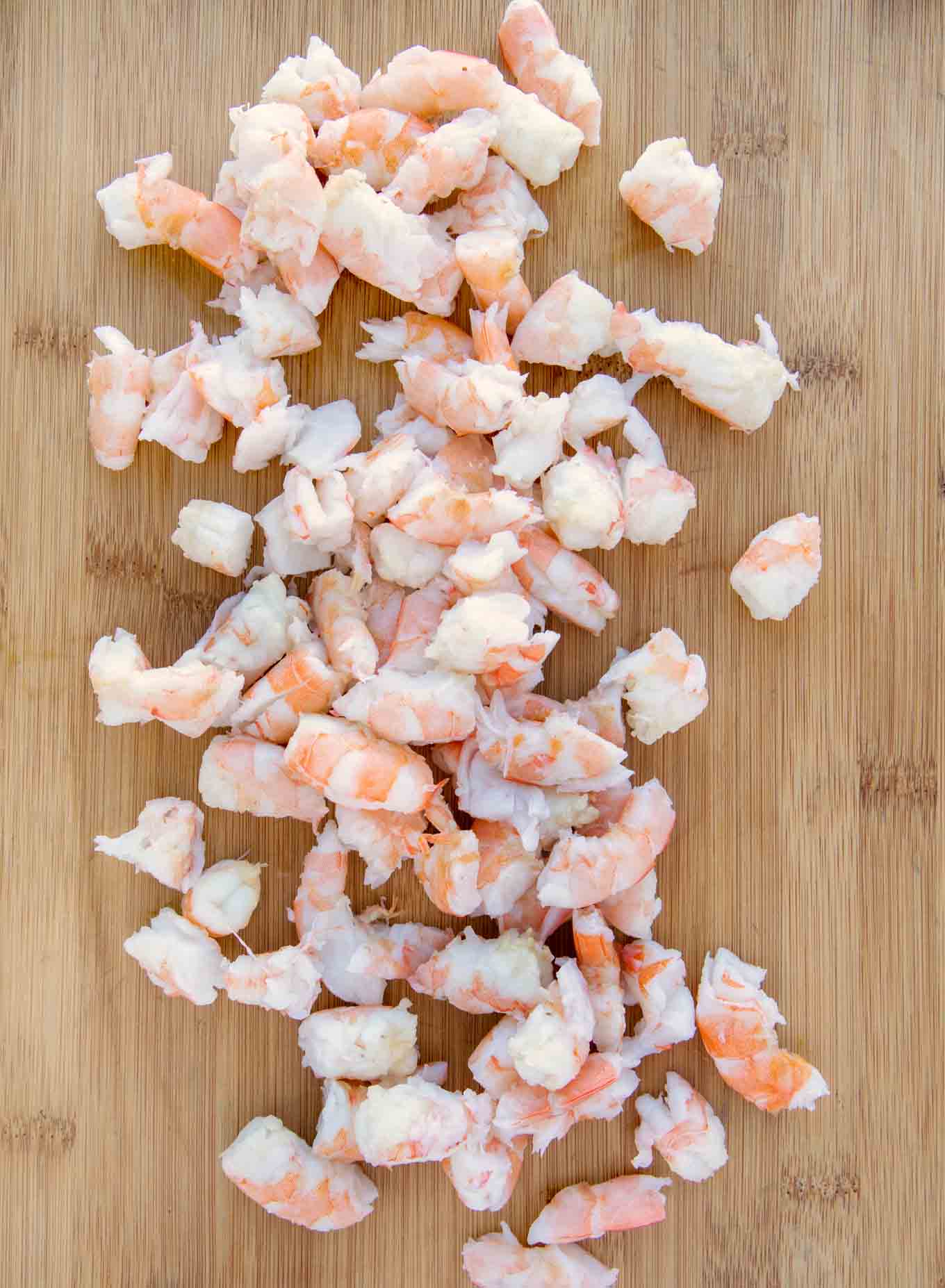 Chopped shrimp on a cutting board.