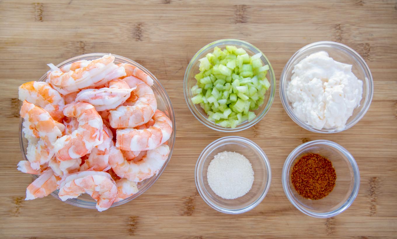 Ingredients required to make the recipe prepared in bowls on a cutting board.