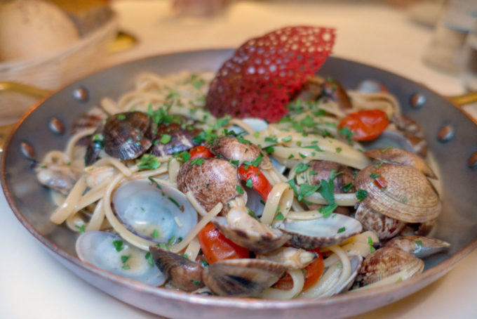 pasta and clams in a round cooking pan, Trento Italy