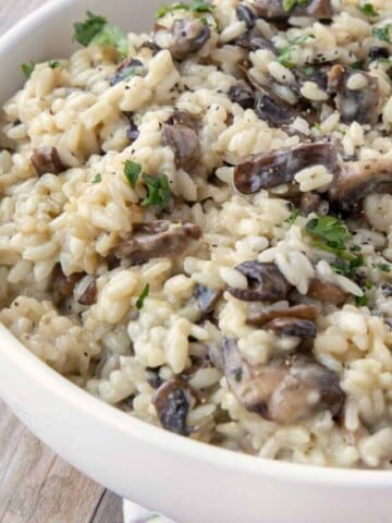 mushroom risotto in a white bowl