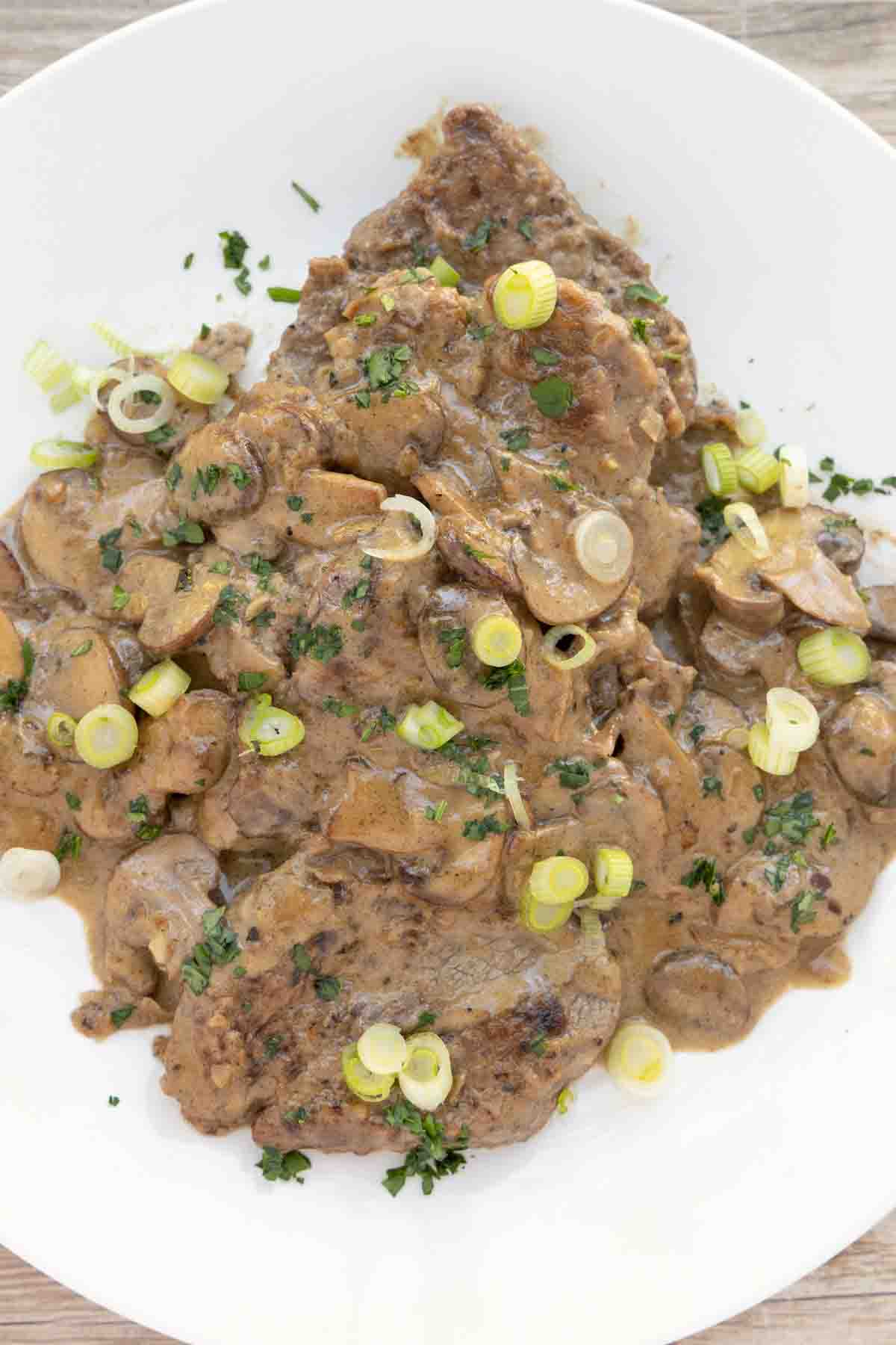 Steak Diane on a white plate.