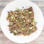 Steak Diane on a white plate.