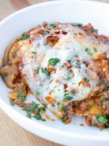 ravioli with plant based bolognese in white bowl