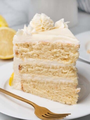 slice of lemon buttermilk cake on white plate with fork