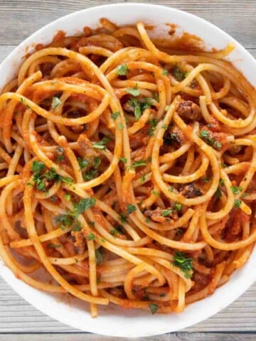 bucatini all' amatriciana in a white bowl