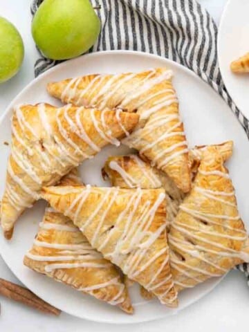 apple turnovers on white platter.