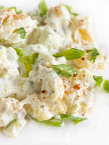 Potato salad on a white plate.