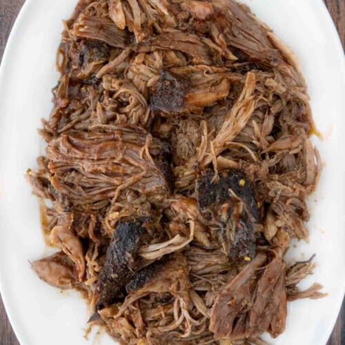 https://www.askchefdennis.com/wp-content/uploads/2023/08/bbq-smoked-pulled-pork-hero-10-500x500.jpg