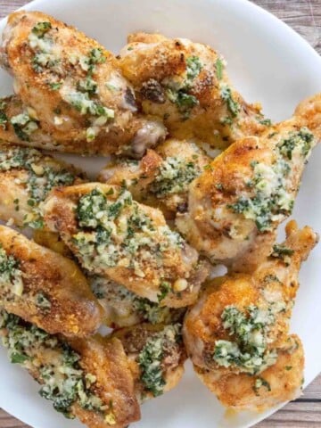 Garlic parmesan wings on a white platter.