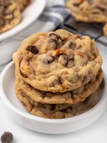 Kitchen sink cookies stacked in a white dish.