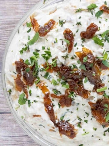 French onion dip in a glass bowl.