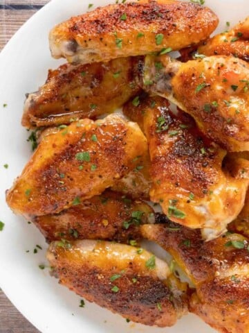 Honey Sriracha Chicken Wings on a white platter.