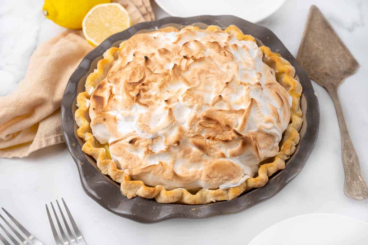 Whole lemon meringue pie in the pie dish.