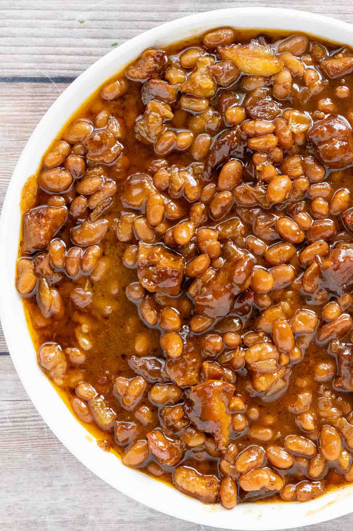 smoked baked beans in a white bowl.