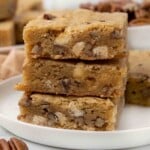 Three blondies stacked on a white plate.