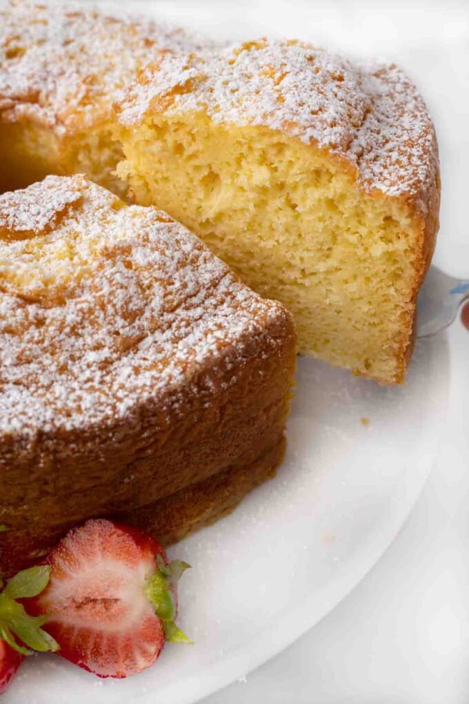 Slice being taken out of whole chiffon cake.