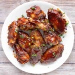 honey barbecue chicken wings on a white plate.