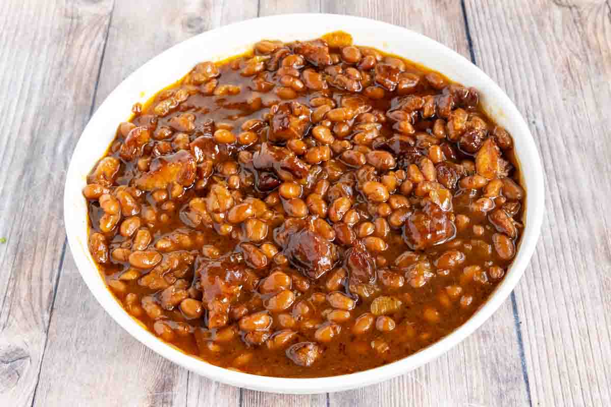 smoked baked beans in a white bowl.