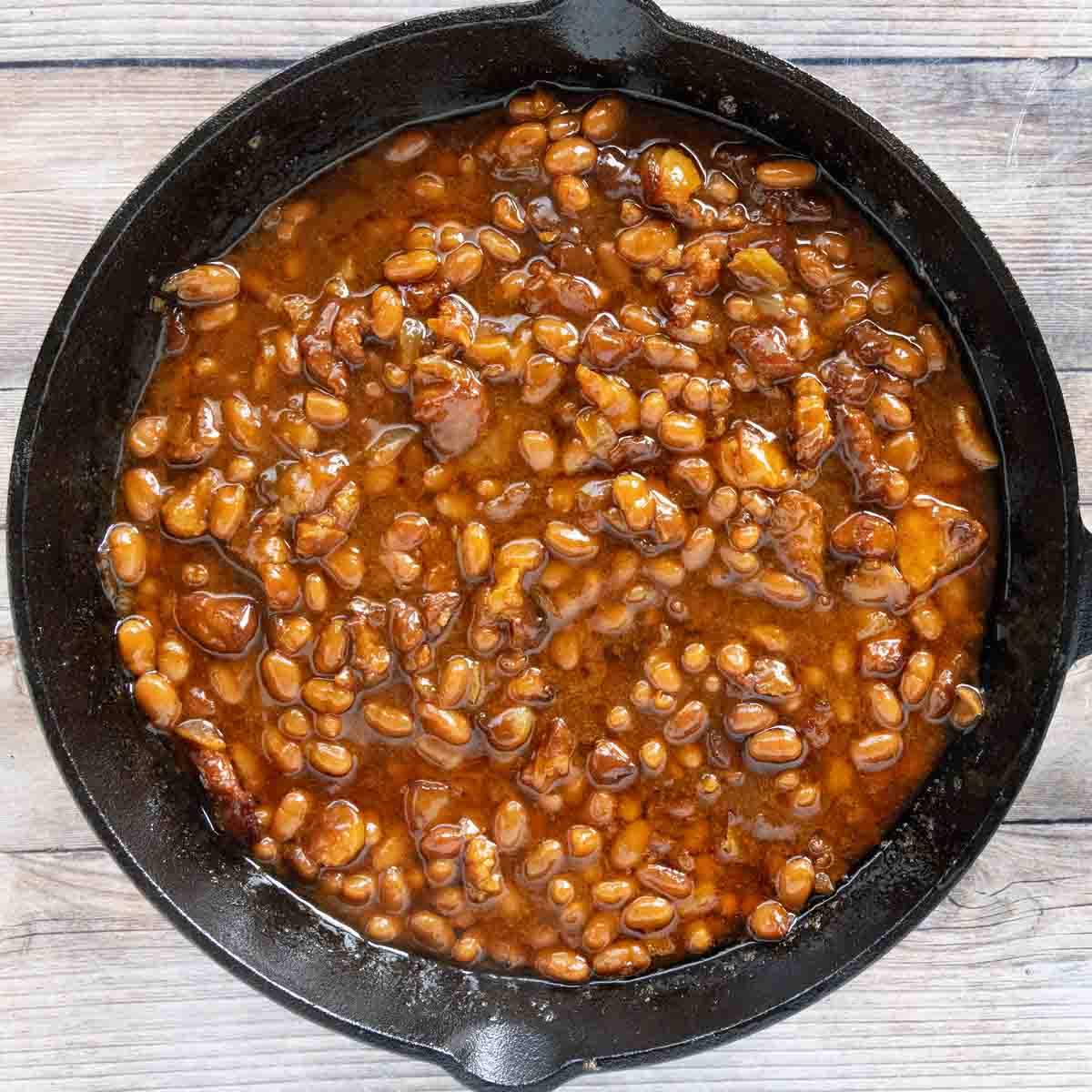 smoked baked beans in a cast iron skillet.