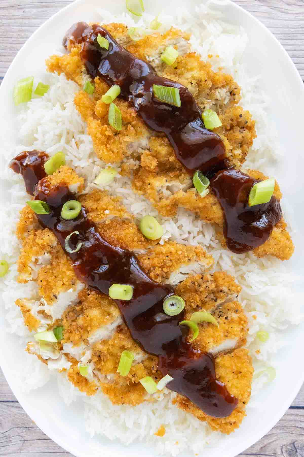 Katsu Chicken served over white rice with tonkatsu sauce.