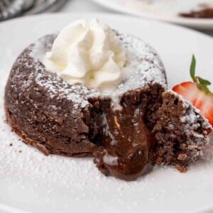 Lava cake cut open with the chocolate oozing onto the plate.