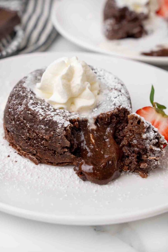 Lava cake cut open with the chocolate oozing onto the plate.