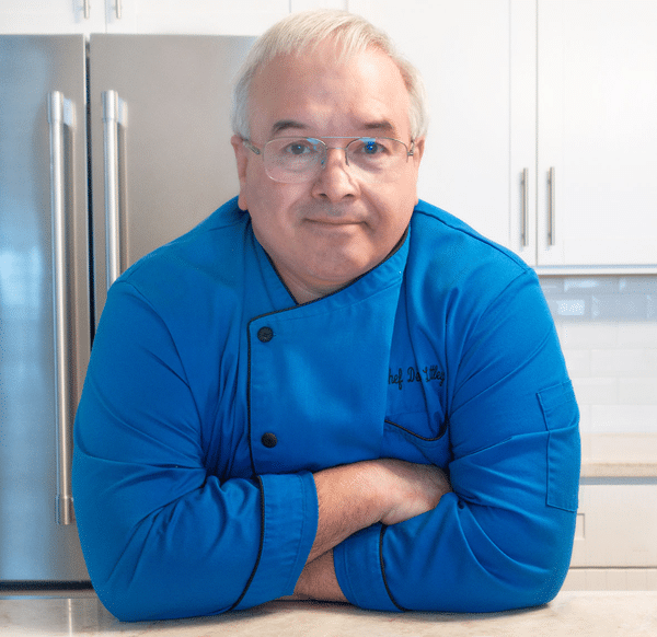 Chef Dennis Littley in a blue chef coat.