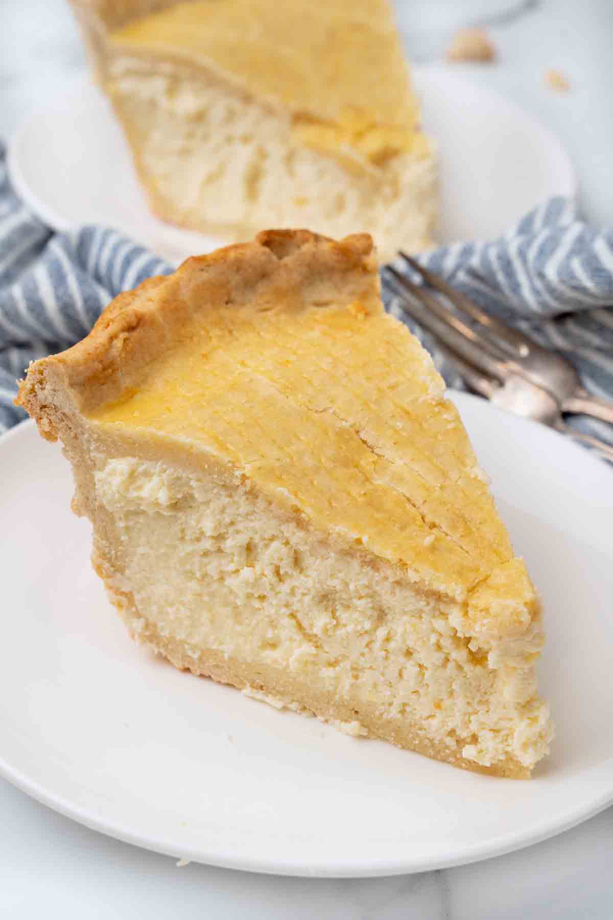 Slice of ricotta pie on a white plate.