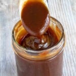 Tonkatsu sauce in a glass jar with a spoon coming out.