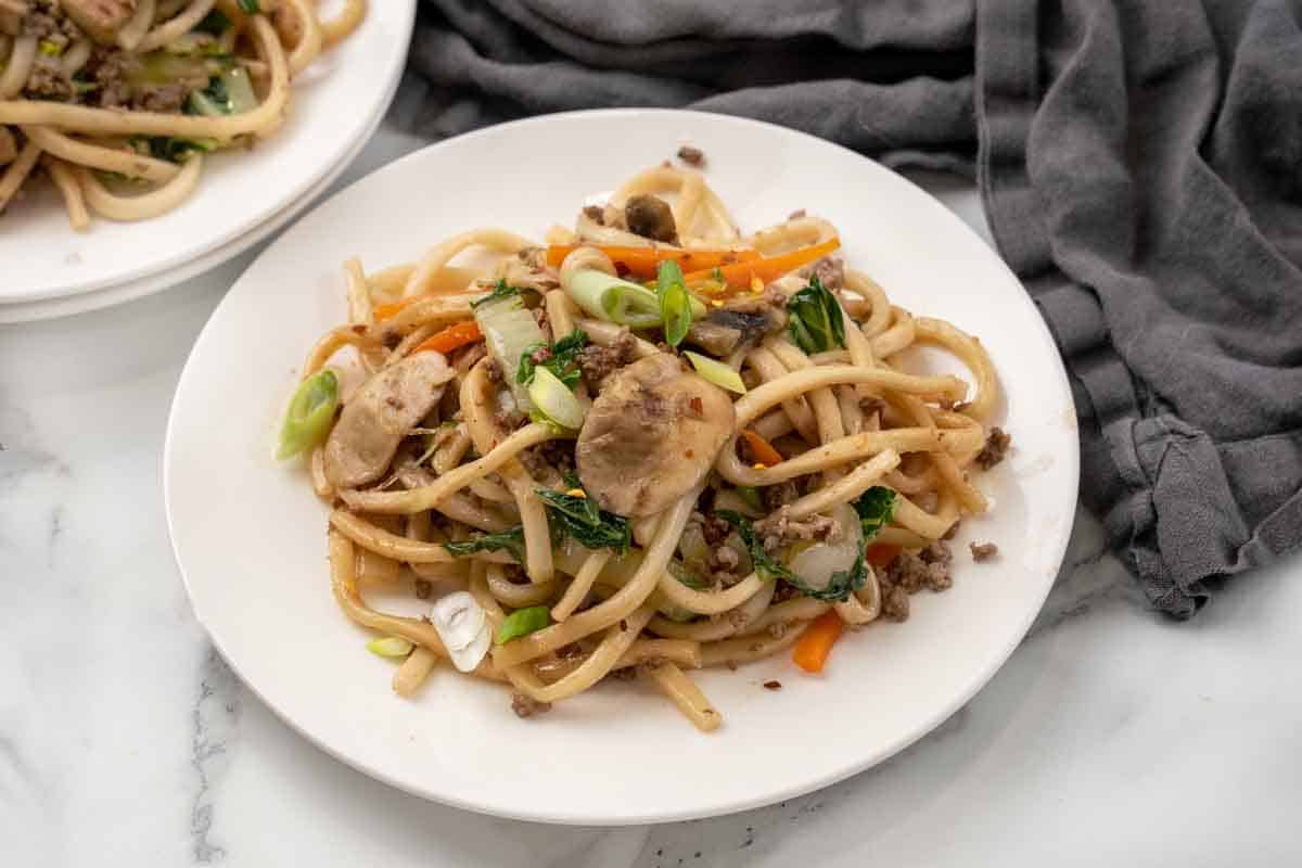 Yaki Udon stir fry on a white plate.