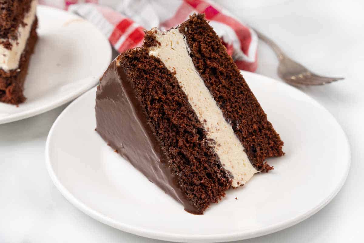 Slice of ding dong cake on a white plate.