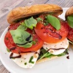 Caprese sandwich on a white plate.