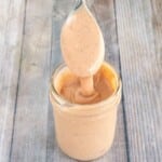 Comeback sauce in a glass jar with a spoon coming out.