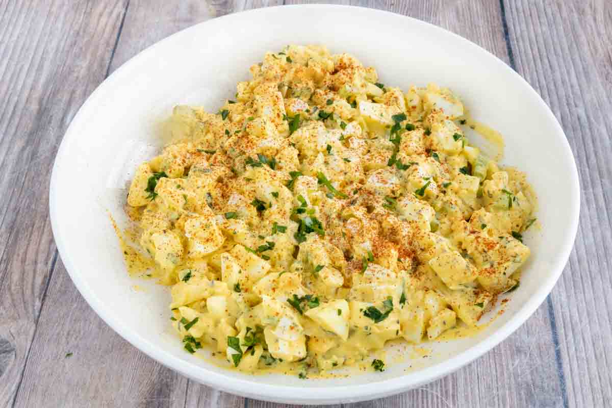 Egg salad in a white bowl.