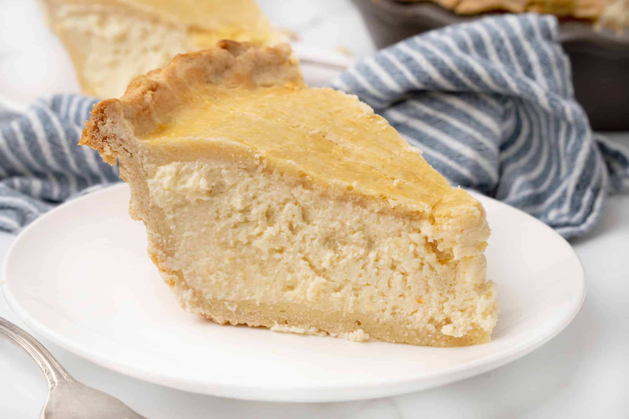 Slice of ricotta pie on a white plate.