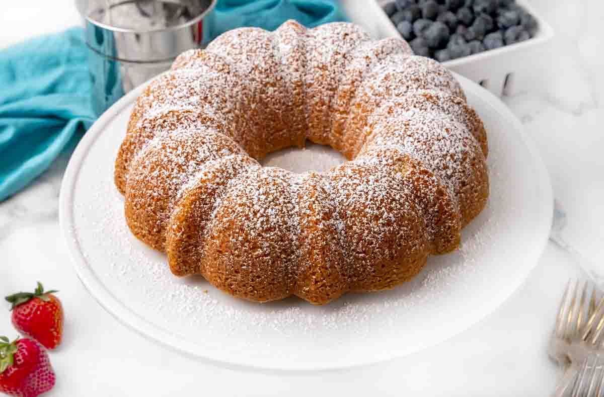 Whole Vanilla bundt cake on a white platter.