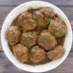 Smoked meatballs and gravy in a white bowl.