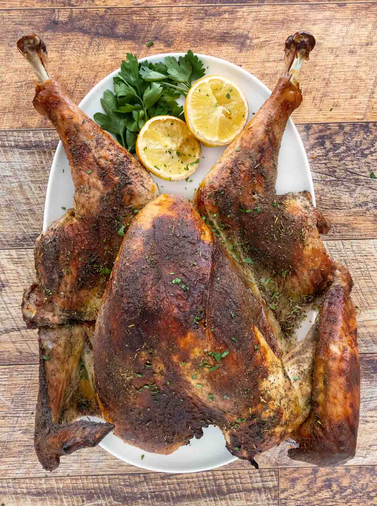 Brined turkey on a white platter.