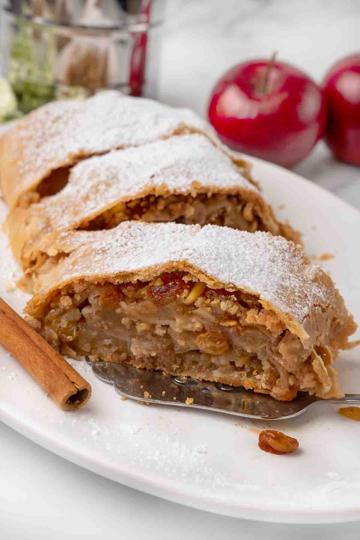 sliced apple strudel on a white platter.