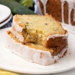 Two slices of lemon zucchini bread on a white plate.