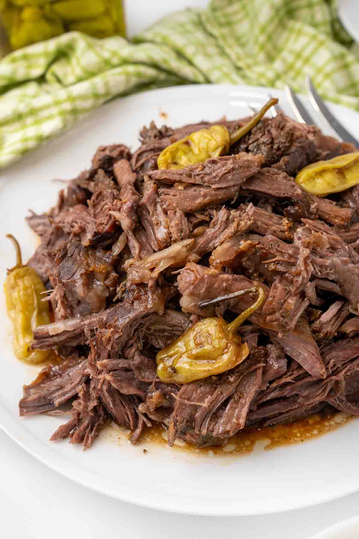 Shredded MIssissippi pot roast on a white plate.