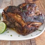 Pernil (Puerto Rican roast pork) on a white platter.