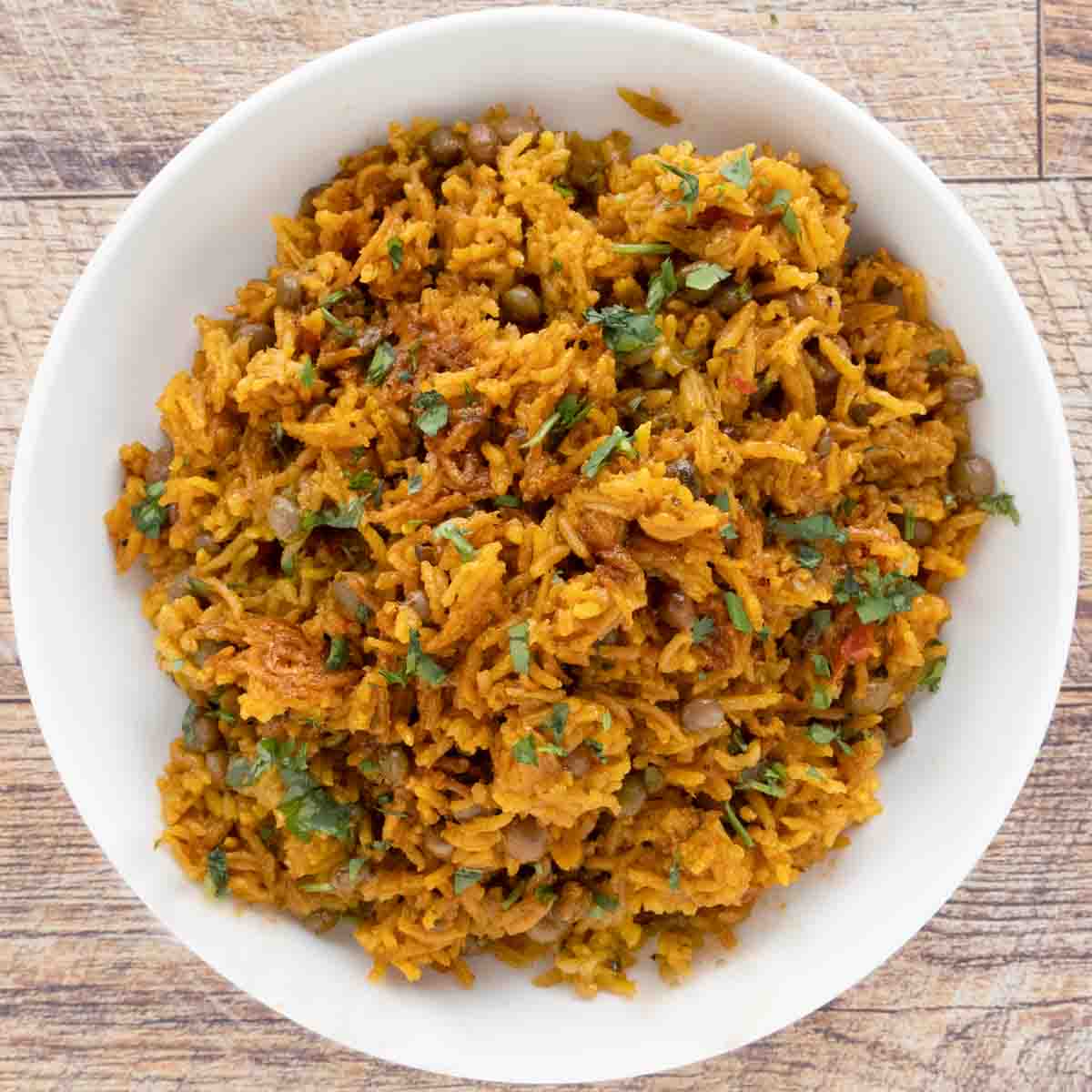 Arroz con Gandules (Puerto Rican rice) in a white bowl.