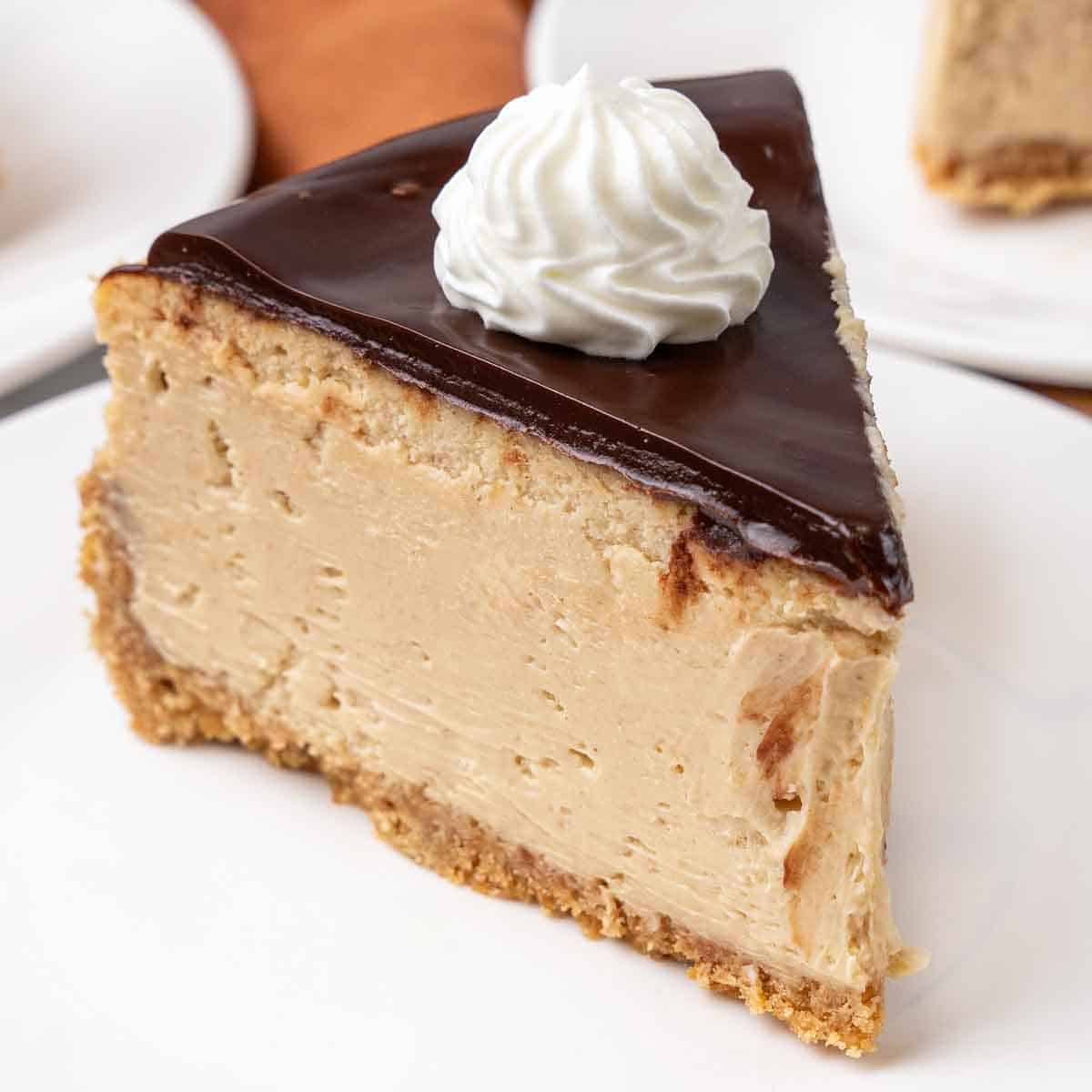 Slice of peanut butter cheesecake on a white plate.