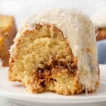 Slice of Tom Cruise Coconut Cake on a white plate.