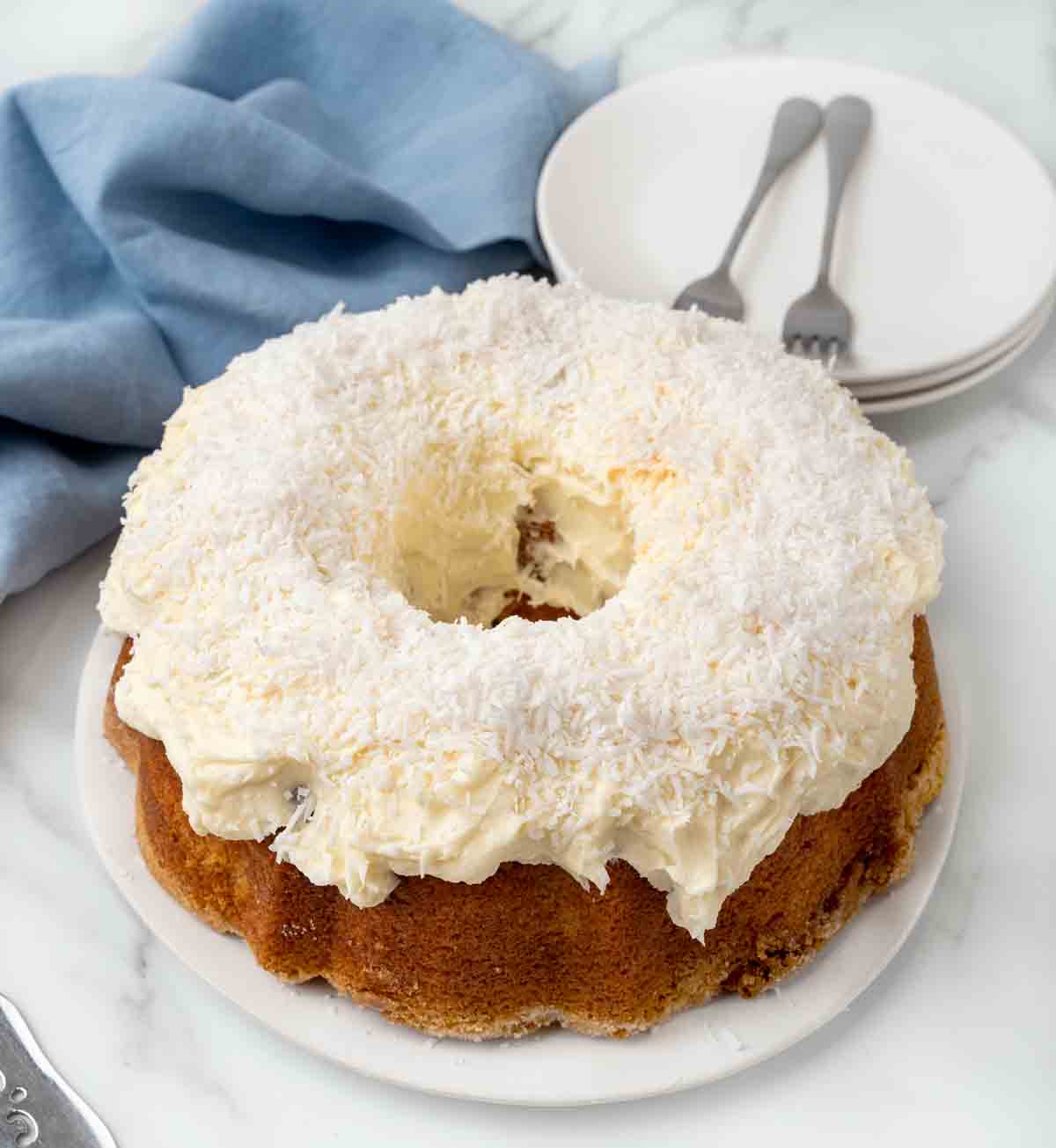 Whole Tom Cruise Coconut Cake on a white platter.