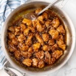 General Tso's chicken in the skillet with toasted sesame seeds sprinkled on top.