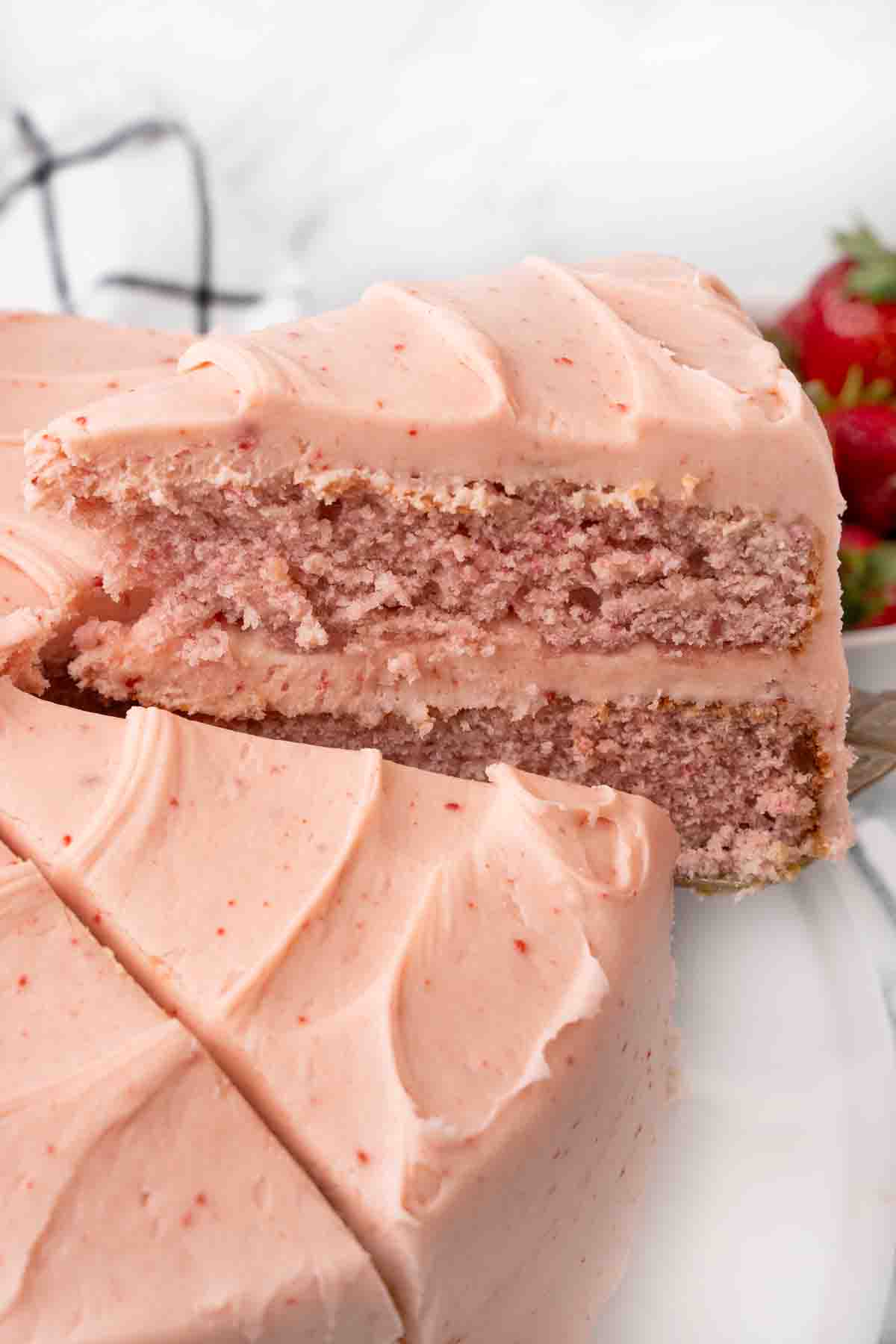 slice being taken out of the strawberry cake.