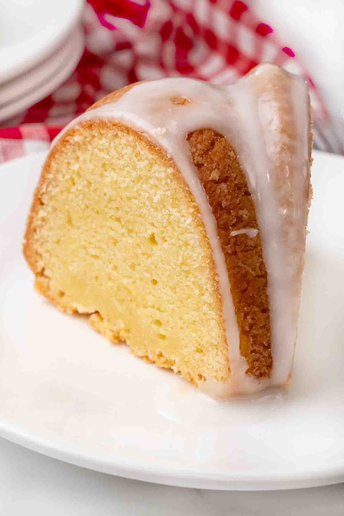 Slice of 7-up cake on a white plate.